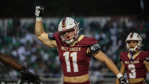 Mill Creek's Luke Mentz (11) celebrates a defensive stop against Buford as Trajen Greco looks on. 11/13/2023